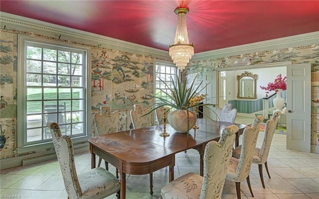 dining area with a chandelier, crown molding, and light tile patterned floors