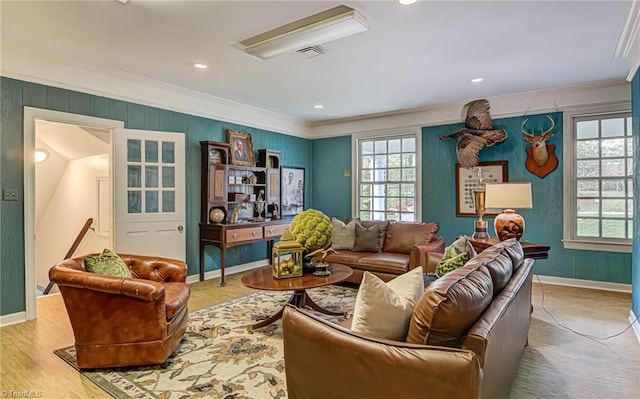 living room with crown molding and wood-type flooring