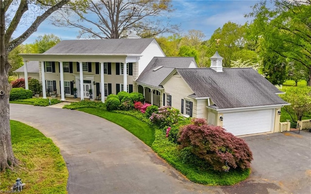 view of front facade with covered porch and a garage