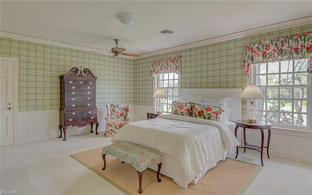 carpeted bedroom featuring ornamental molding, multiple windows, and ceiling fan