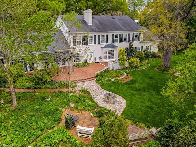 back of house featuring a yard and a patio