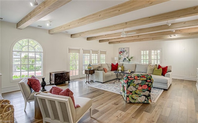 living room with french doors, beam ceiling, light wood-type flooring, and ceiling fan