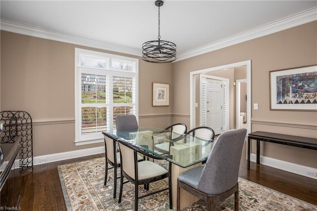 dining area with baseboards, dark wood finished floors, and ornamental molding