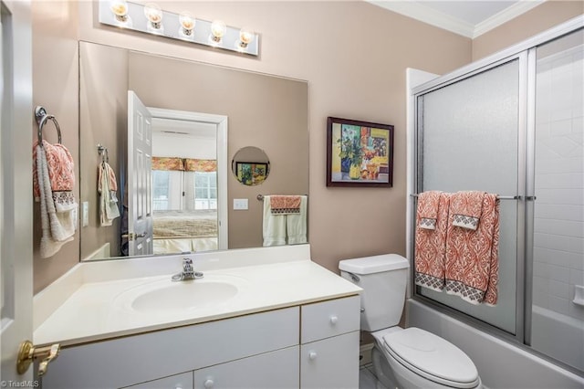 bathroom featuring vanity, ensuite bathroom, crown molding, toilet, and combined bath / shower with glass door