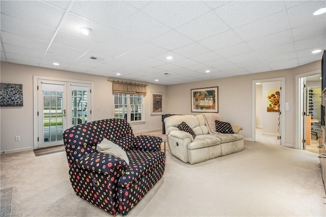 living room featuring french doors, baseboards, carpet, and visible vents