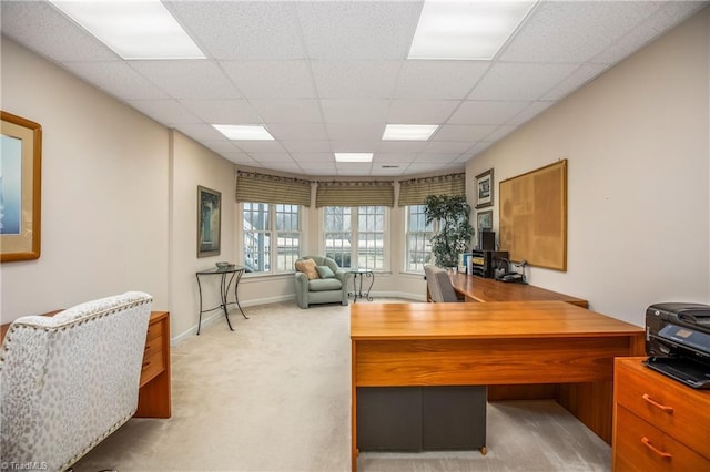 office with baseboards, a paneled ceiling, and light colored carpet