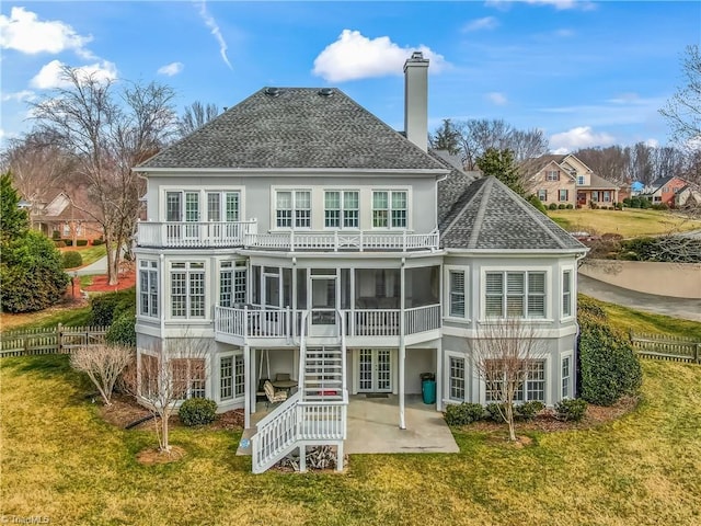 back of property featuring french doors, a yard, a sunroom, a balcony, and a patio area