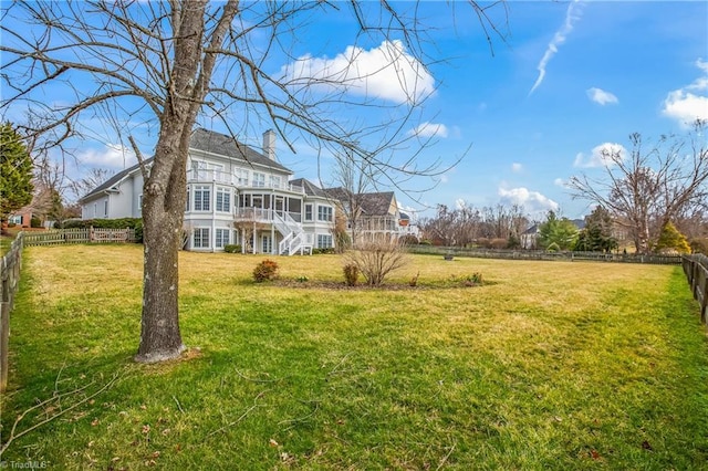 view of yard featuring a fenced backyard and stairs