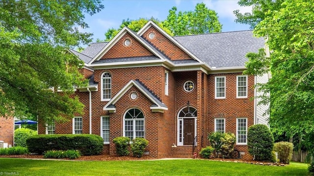 1905 Regents Park Ln, Greensboro, NC 27455 - colonial inspired home with a front lawn, brick siding, and a shingled roof