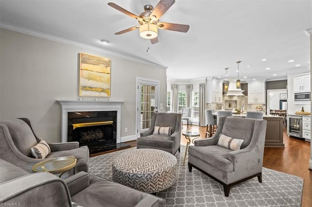 1905 Regents Park Ln, Greensboro, NC 27455 - living area with ornamental molding, dark wood finished floors, recessed lighting, a fireplace, and ceiling fan