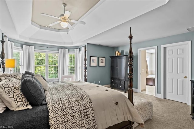 1905 Regents Park Ln, Greensboro, NC 27455 - carpeted bedroom with a tray ceiling, ceiling fan, ensuite bathroom, and baseboards