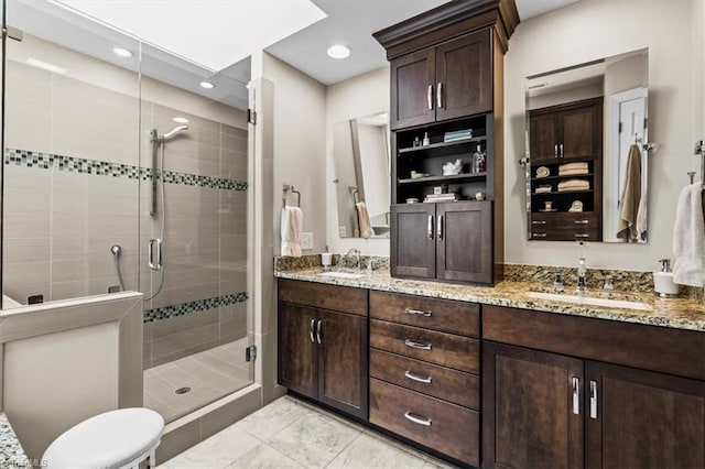 1905 Regents Park Ln, Greensboro, NC 27455 - bathroom featuring double vanity, a stall shower, recessed lighting, and tile patterned flooring