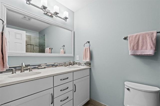 1905 Regents Park Ln, Greensboro, NC 27455 - full bath featuring double vanity, toilet, tiled shower, and baseboards