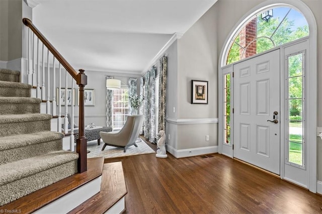 1905 Regents Park Ln, Greensboro, NC 27455 - entryway with stairs, plenty of natural light, wood finished floors, baseboards, and ornamental molding