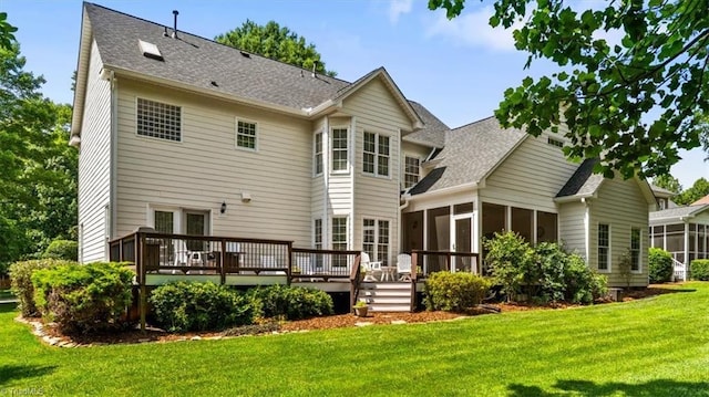 1905 Regents Park Ln, Greensboro, NC 27455 - back of house featuring a sunroom, a deck, a lawn, and roof with shingles