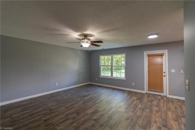empty room with dark wood-style floors, baseboards, ceiling fan, and a textured ceiling