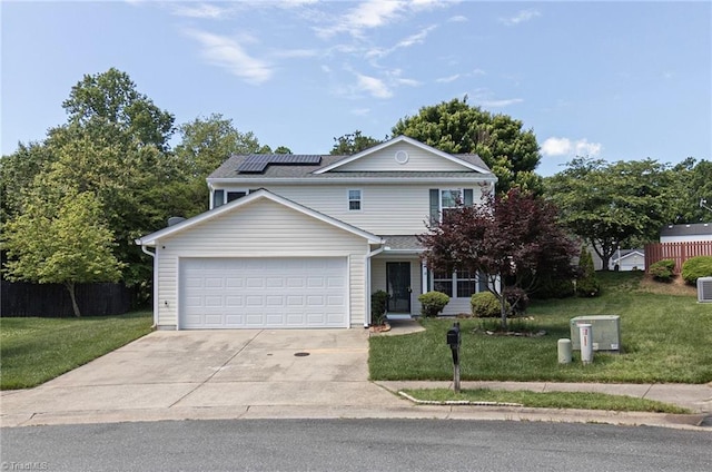 traditional home with solar panels, a front lawn, a garage, and concrete driveway
