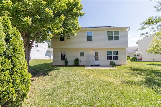 rear view of property with a patio area and a lawn