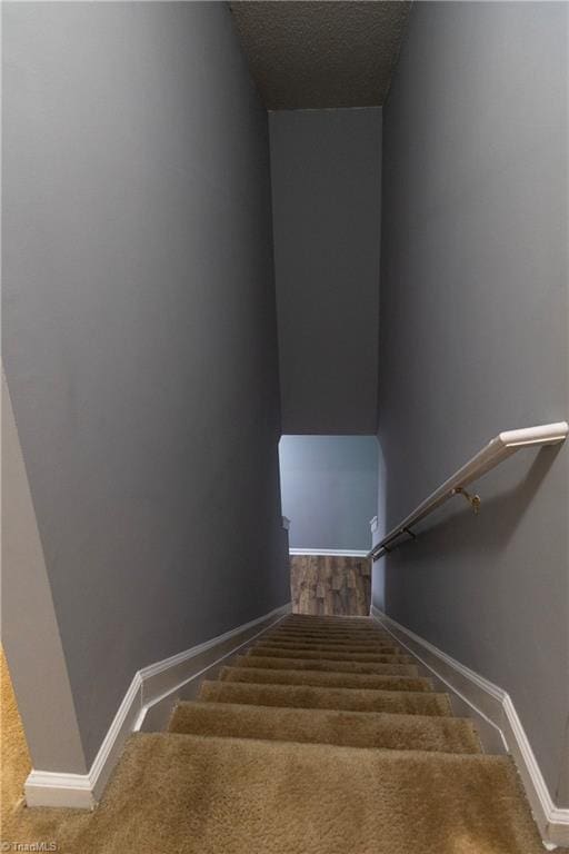 staircase featuring baseboards