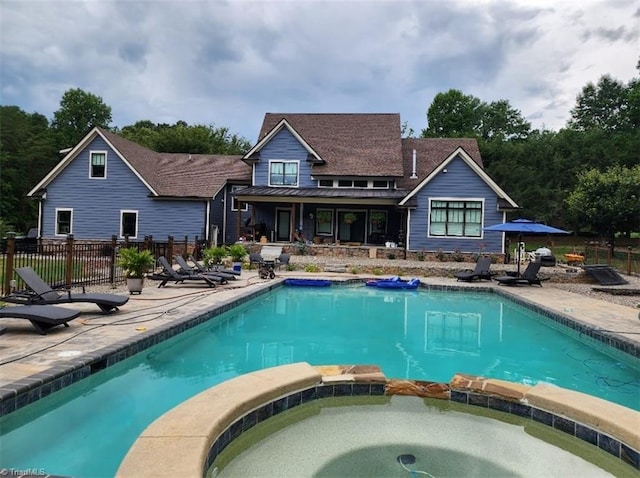 exterior space with an in ground hot tub and a patio area