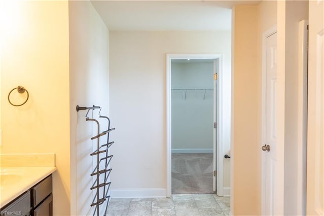 4008 Meadow Valley Dr, High Point, NC 27265 - bathroom featuring vanity, baseboards, and a spacious closet