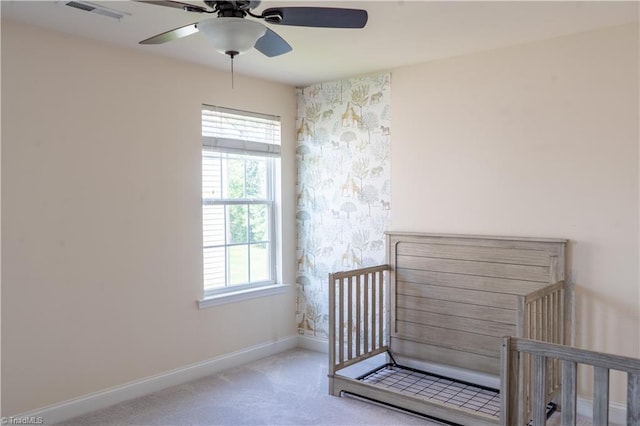 4008 Meadow Valley Dr, High Point, NC 27265 - unfurnished bedroom featuring baseboards, carpet floors, a ceiling fan, a nursery area, and wallpapered walls