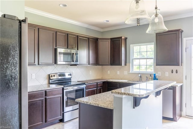 4008 Meadow Valley Dr, High Point, NC 27265 - kitchen featuring stainless steel appliances, a sink, light stone counters, dark brown cabinetry, and a center island