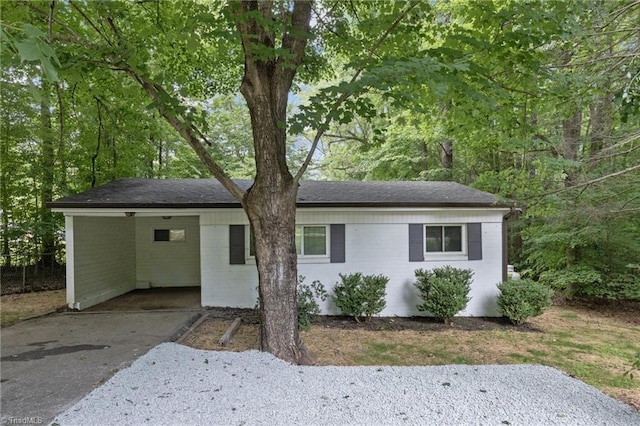 single story home with a carport and driveway