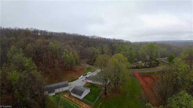 drone / aerial view featuring a view of trees
