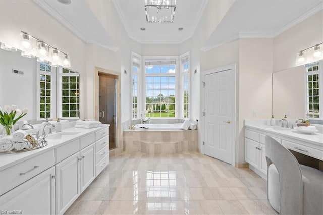 bathroom featuring two vanities, a sink, ornamental molding, a shower stall, and a bath