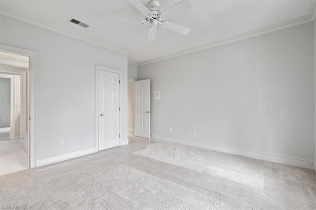 unfurnished bedroom featuring visible vents, ornamental molding, a ceiling fan, carpet flooring, and baseboards