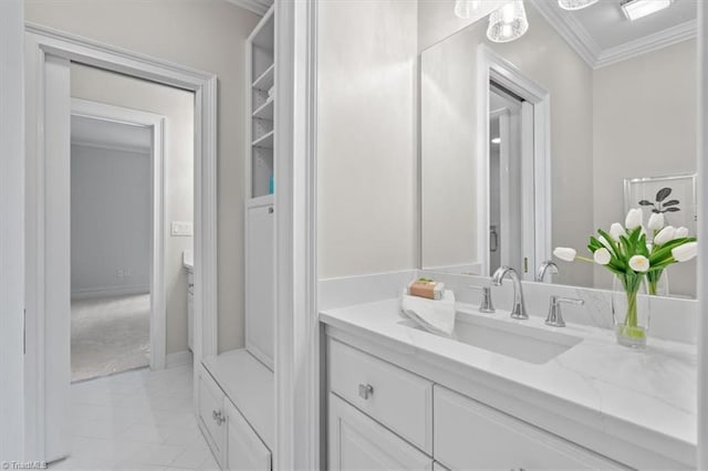 bathroom featuring ornamental molding, marble finish floor, vanity, and baseboards