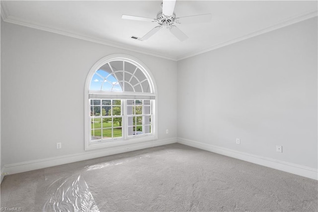 unfurnished room featuring a ceiling fan, carpet, crown molding, and baseboards