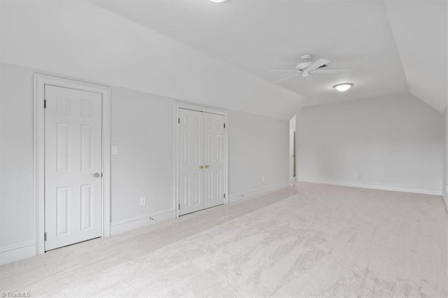 additional living space featuring vaulted ceiling, carpet flooring, a ceiling fan, and baseboards