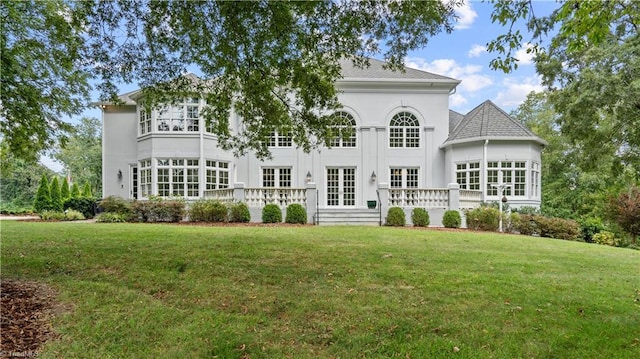 rear view of property with a yard and french doors