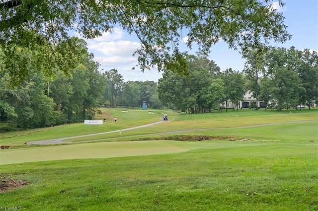 view of home's community with a yard and view of golf course