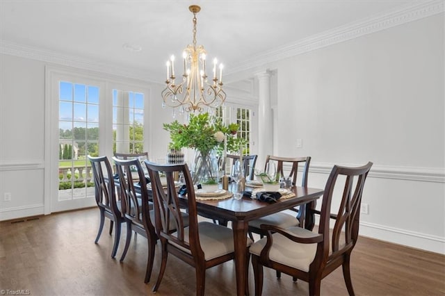 dining space featuring baseboards, plenty of natural light, ornamental molding, and wood finished floors