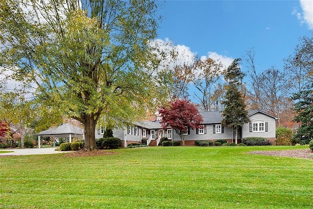 ranch-style house featuring a front yard and a carport