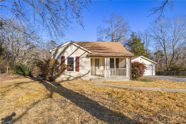 view of front of house with an outbuilding, a porch, and a garage