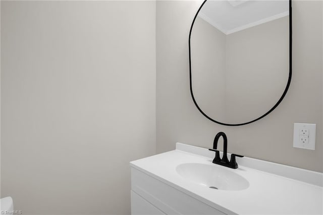 bathroom with ornamental molding and vanity