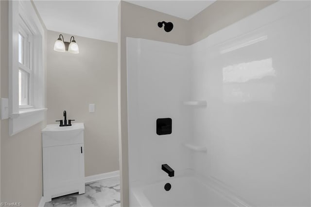 bathroom featuring vanity and  shower combination