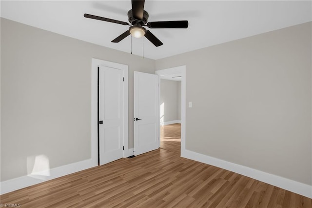 unfurnished bedroom featuring ceiling fan and light wood-type flooring