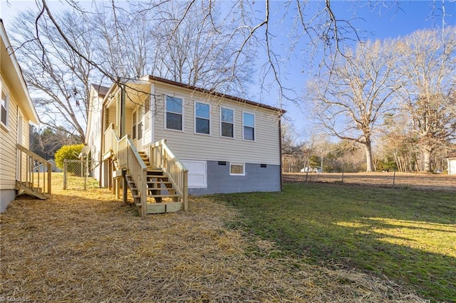 rear view of house with a lawn