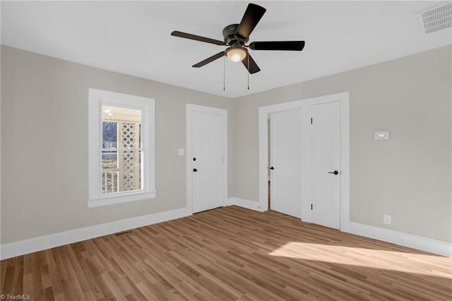 spare room with ceiling fan and light wood-type flooring