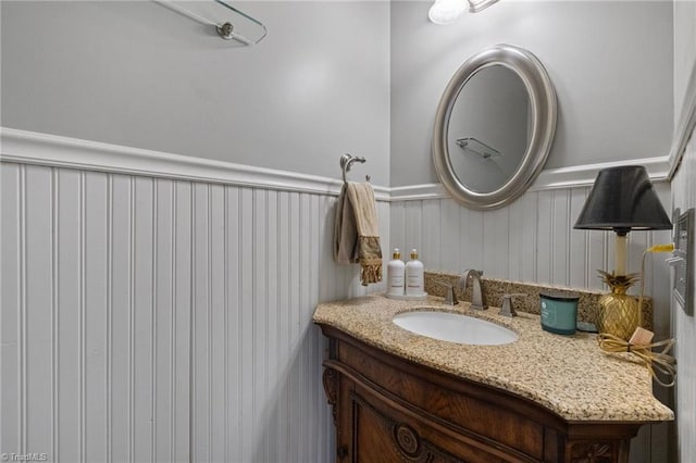 bathroom featuring a wainscoted wall and vanity