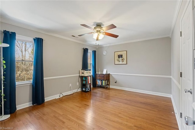 unfurnished room featuring ornamental molding, visible vents, wood finished floors, and ceiling fan