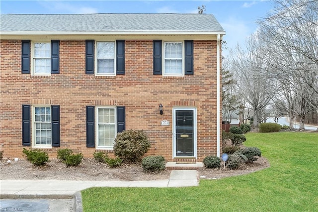 3905 Valley Ct Unit F, Winston-Salem, NC 27106 - view of front of house featuring a front yard, brick siding, and a shingled roof