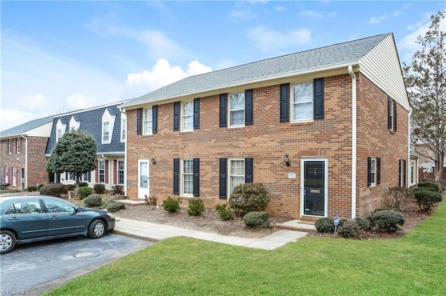 3905 Valley Ct Unit F, Winston-Salem, NC 27106 - view of front of home with a front lawn, uncovered parking, brick siding, and roof with shingles