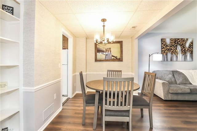 3905 Valley Ct Unit F, Winston-Salem, NC 27106 - dining room featuring a drop ceiling, dark wood-type flooring, a chandelier, and baseboards