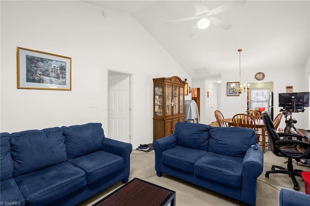 carpeted living room with ceiling fan with notable chandelier and high vaulted ceiling